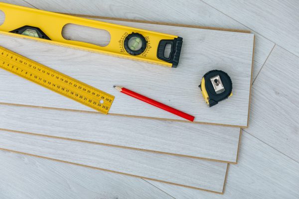 Laminate installing equipment on planks close-up